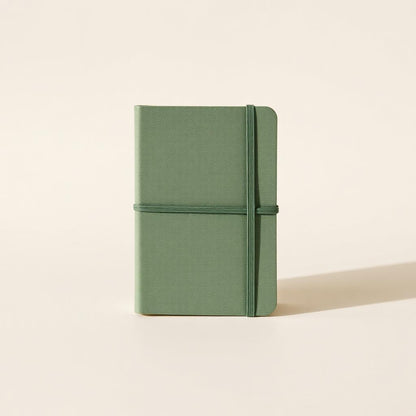 Sage linen notebook on a desk